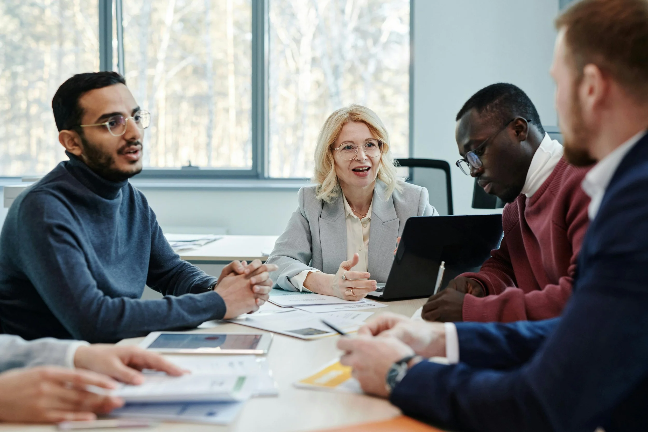 four people in a meeting room in animated discussion