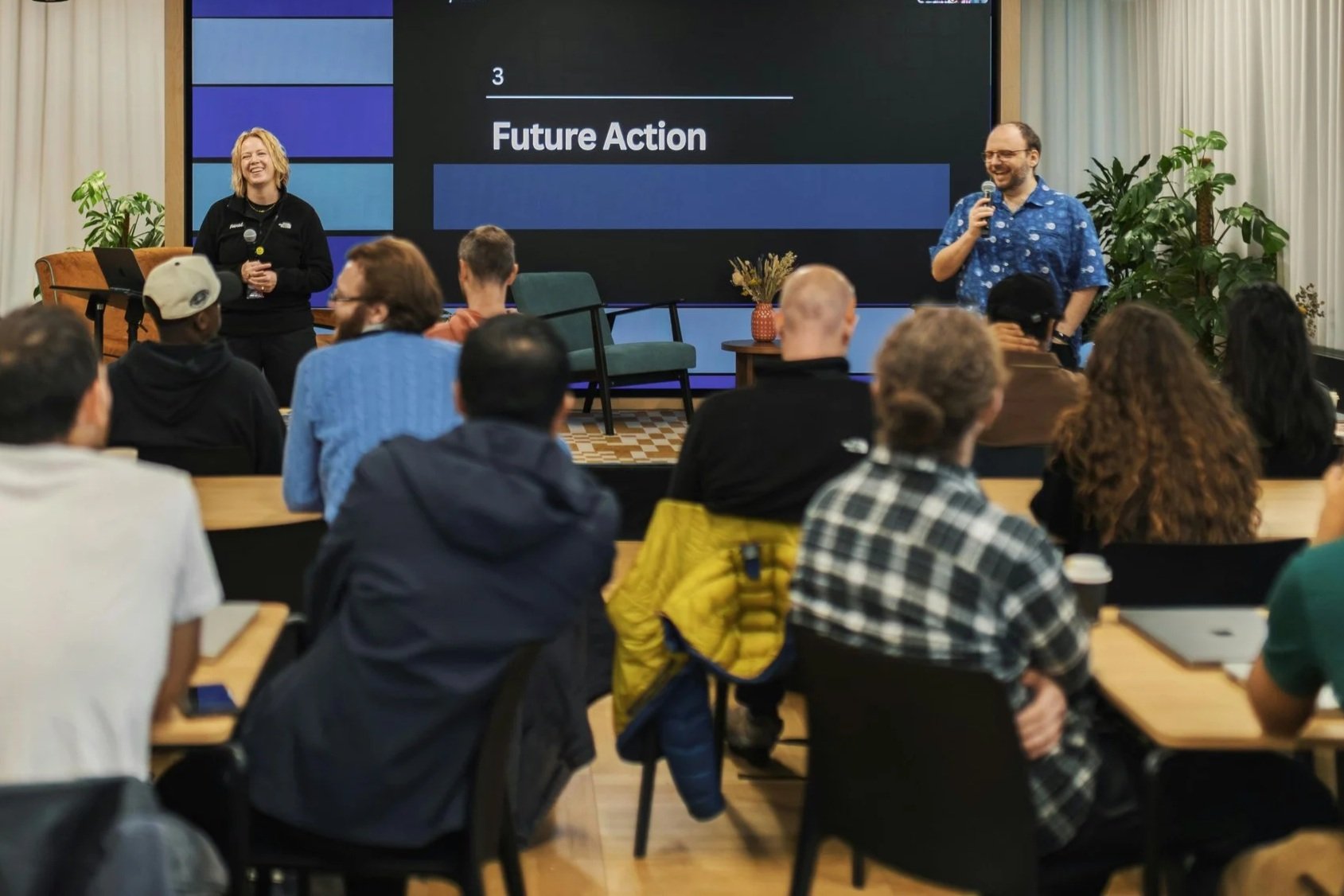 people attending a workshop in a large conference room