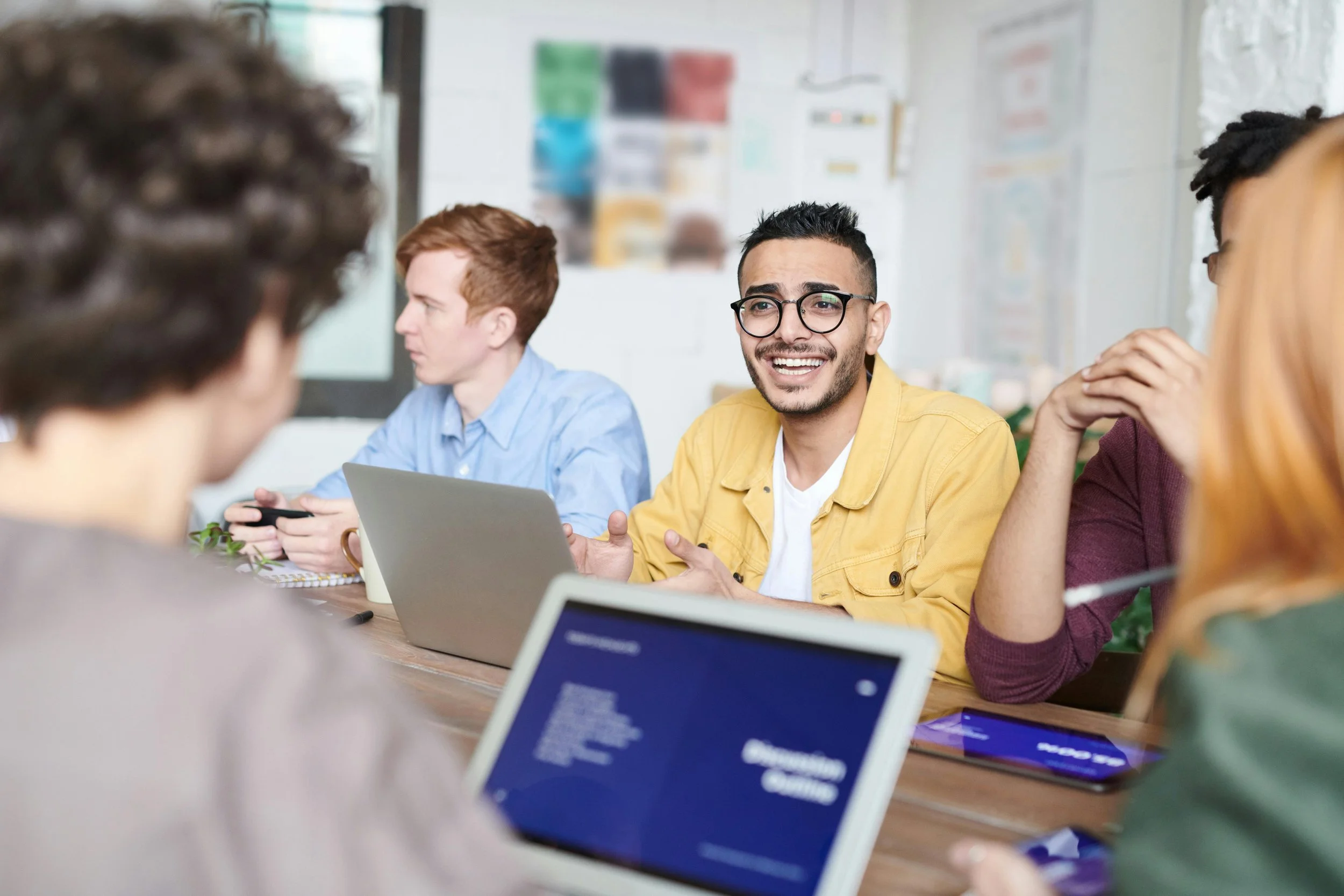 people sitting around the table in a work meeting