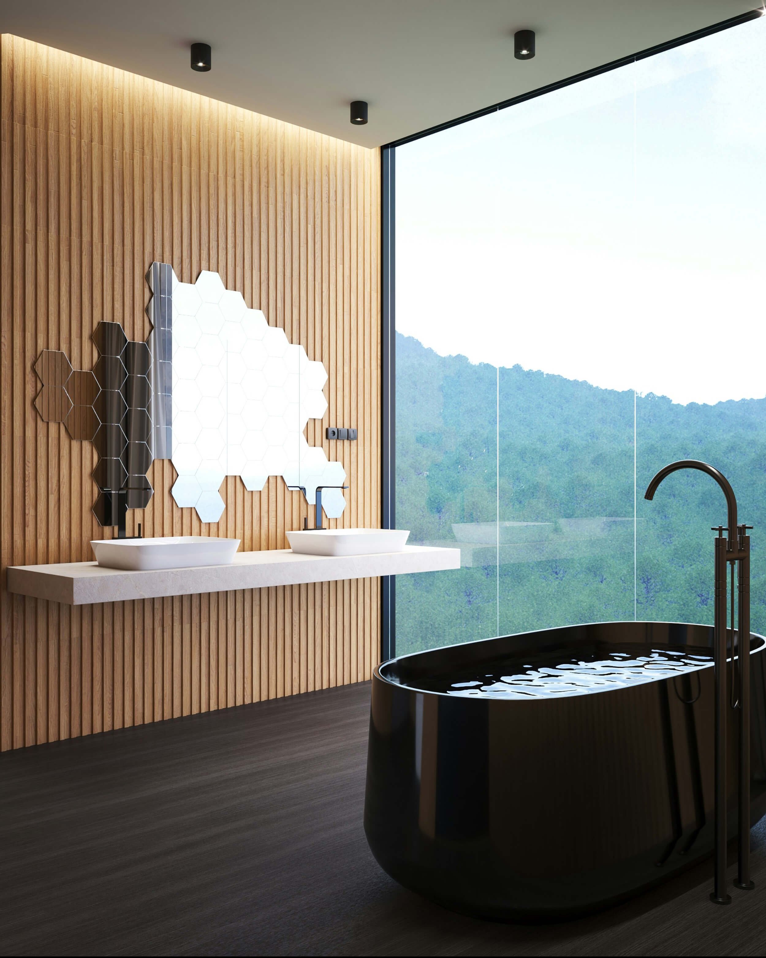 black bathtub next to a big window with a view of lush green trees. There are two sinks on the wall as well as a mirror comprised of hexagonal honeycomb shapes