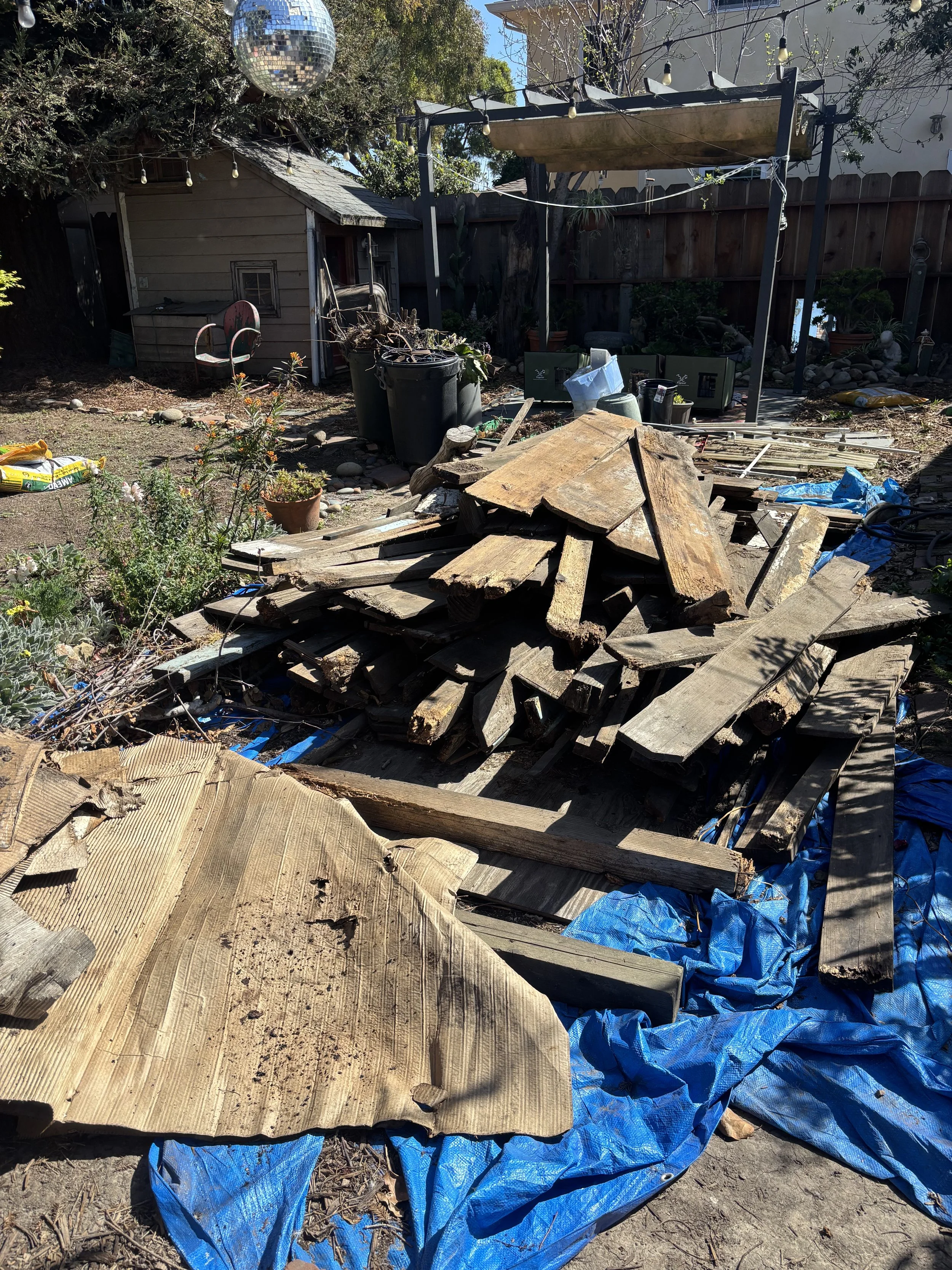 Fence removal and yard cleanout in Salinas California with debris loaded for junk removal by Junk Boys