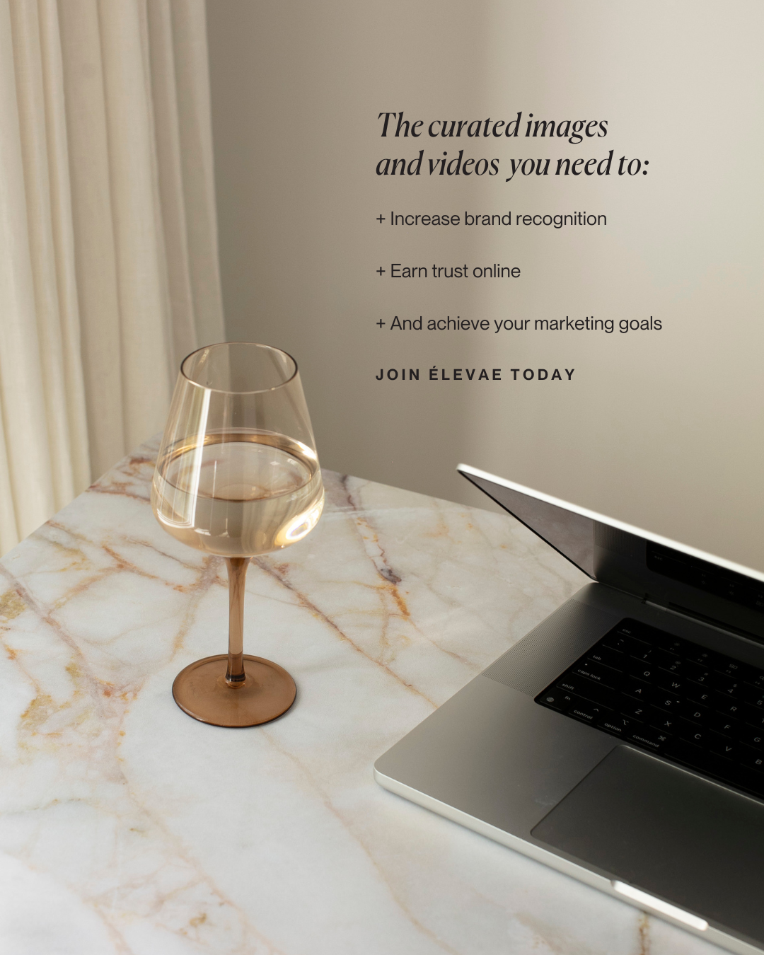 Photo of a laptop and glass on a table with the benefits of Èlevae: increase brand recognition, earn trust online, and achieve your marketing goals