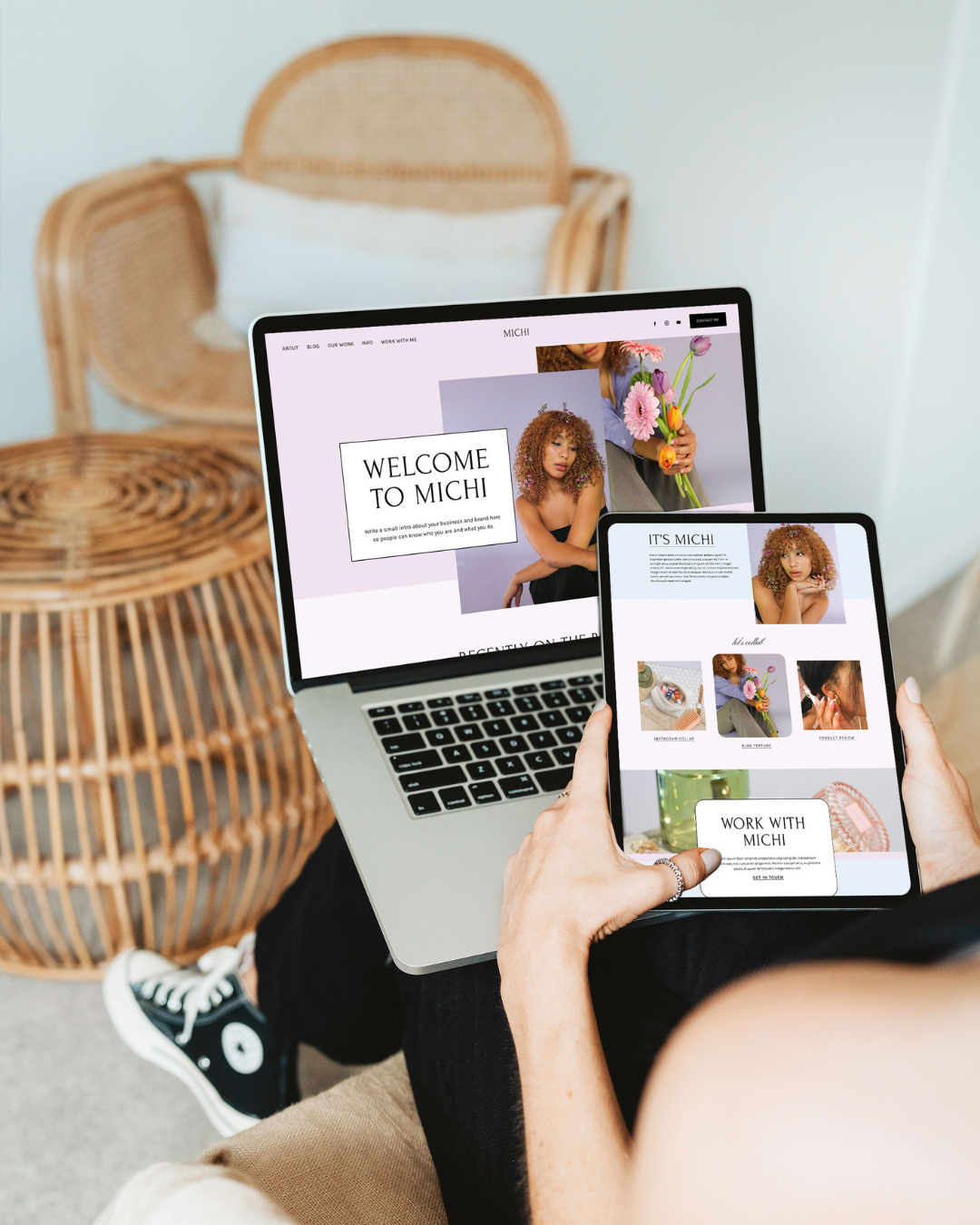 Photo of a woman holding a laptop with the Michi template pulled up