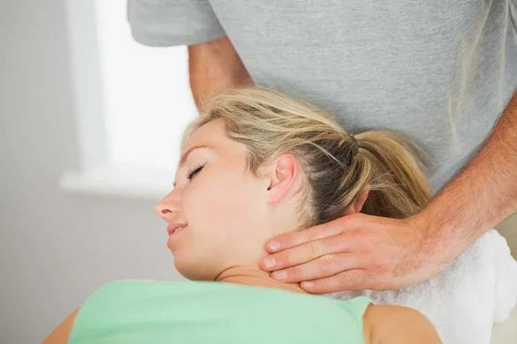 A chiropractor applying gentle pressure to a patient’s neck during a cervical adjustment to relieve tension and restore alignment.