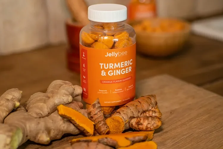 A close-up photograph of fresh turmeric roots, ginger, and organic supplement capsules representing "Nature's Pharmacy."