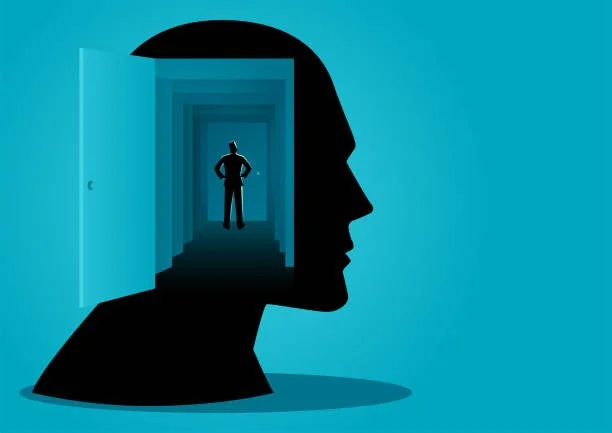 Illustration of a human head silhouette with an open door inside, revealing a man standing in a hallway.