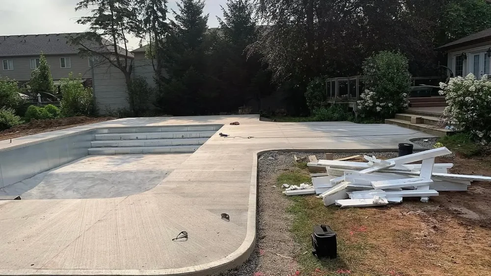 Finished concrete pool shell with broom-finish deck in Niagara Falls