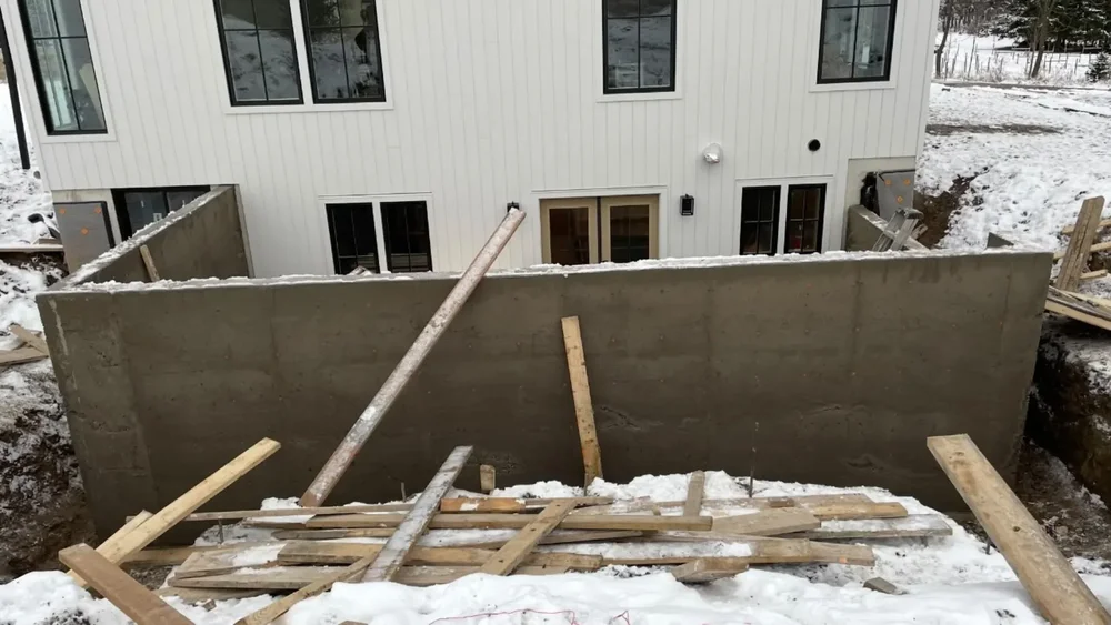 concrete retaining wall for a basement walkout during winter construction