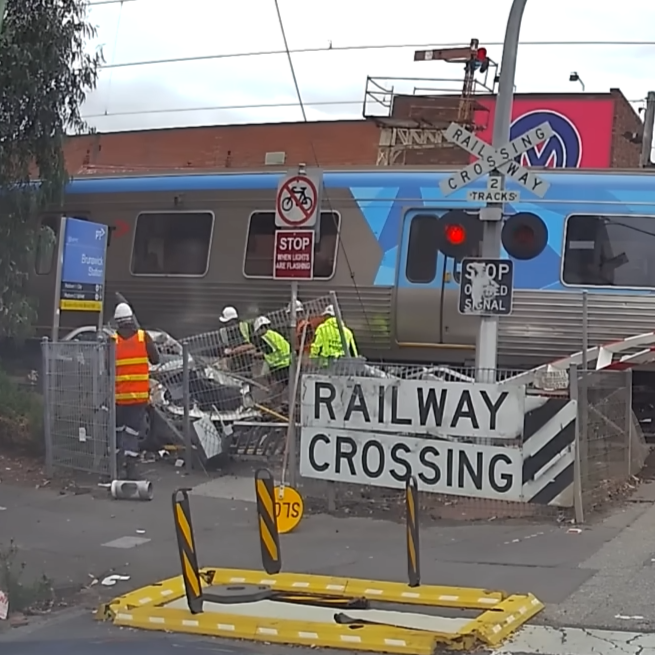 Train smashes car in Melbourne as tradies rush to rescue elderly driver
