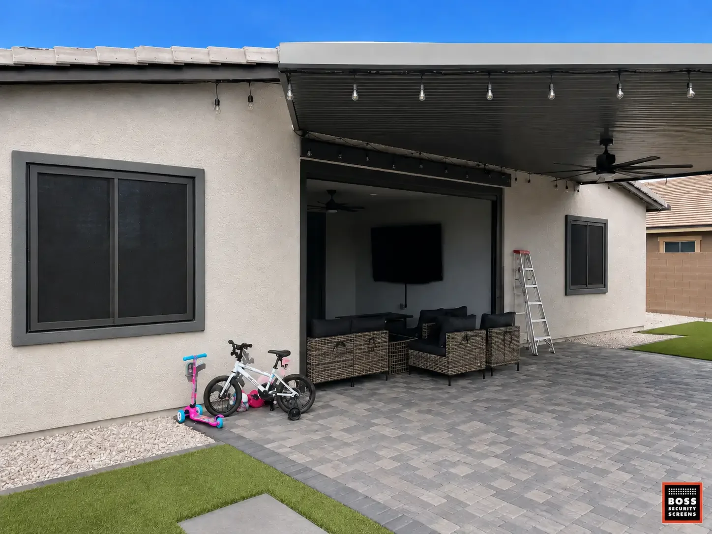 Northridge backyard patio with dark security screen panels on windows and large opening, keeping indoor-outdoor living protected without a fortress look.