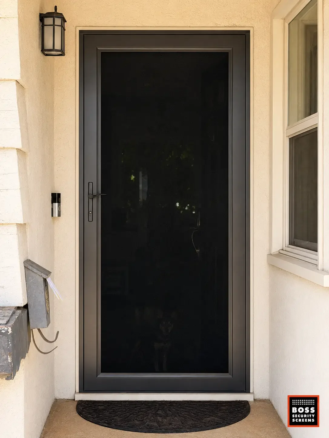 dark-bronze-full-mesh-security-screen-door-with-dog-behind.webp