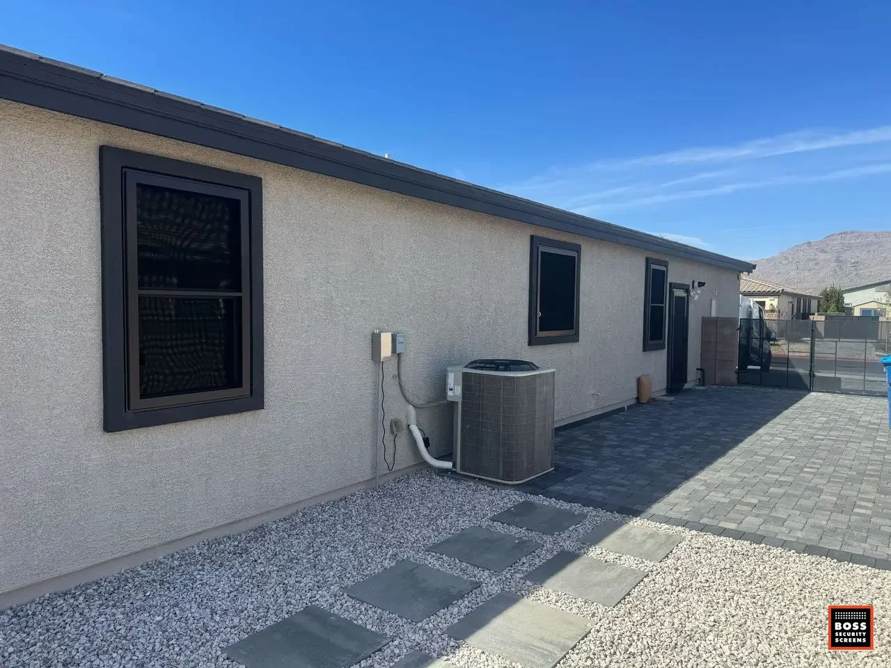 Northridge side yard with dark security screen panels on multiple windows, protecting vulnerable access points without giving the home a fortress look.