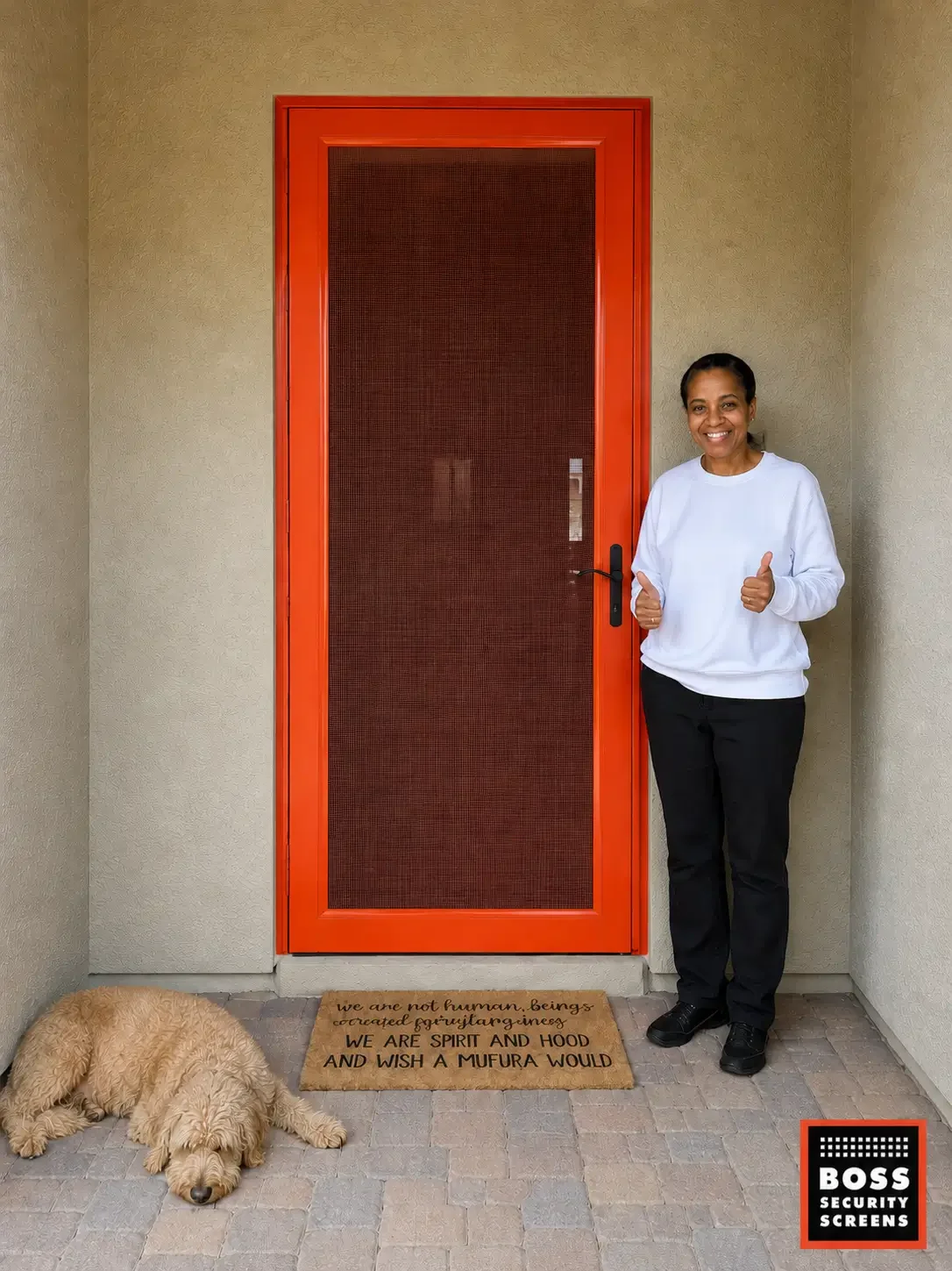 smiling-homeowner-beside-orange-security-screen-door-with-dark-mesh.webp