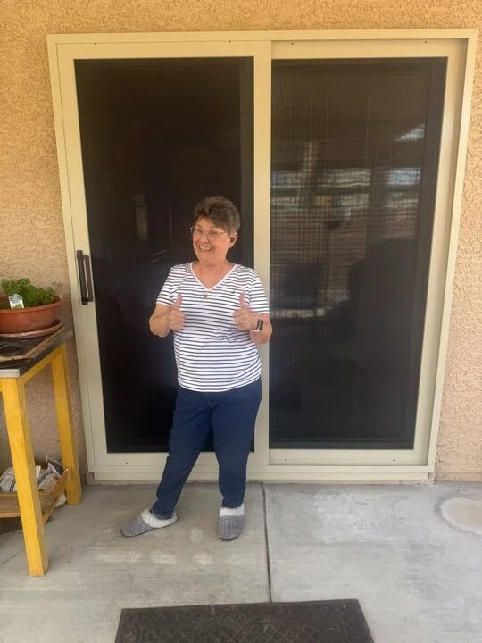 Happy Clients of Boss security screen standing with her new door security screens