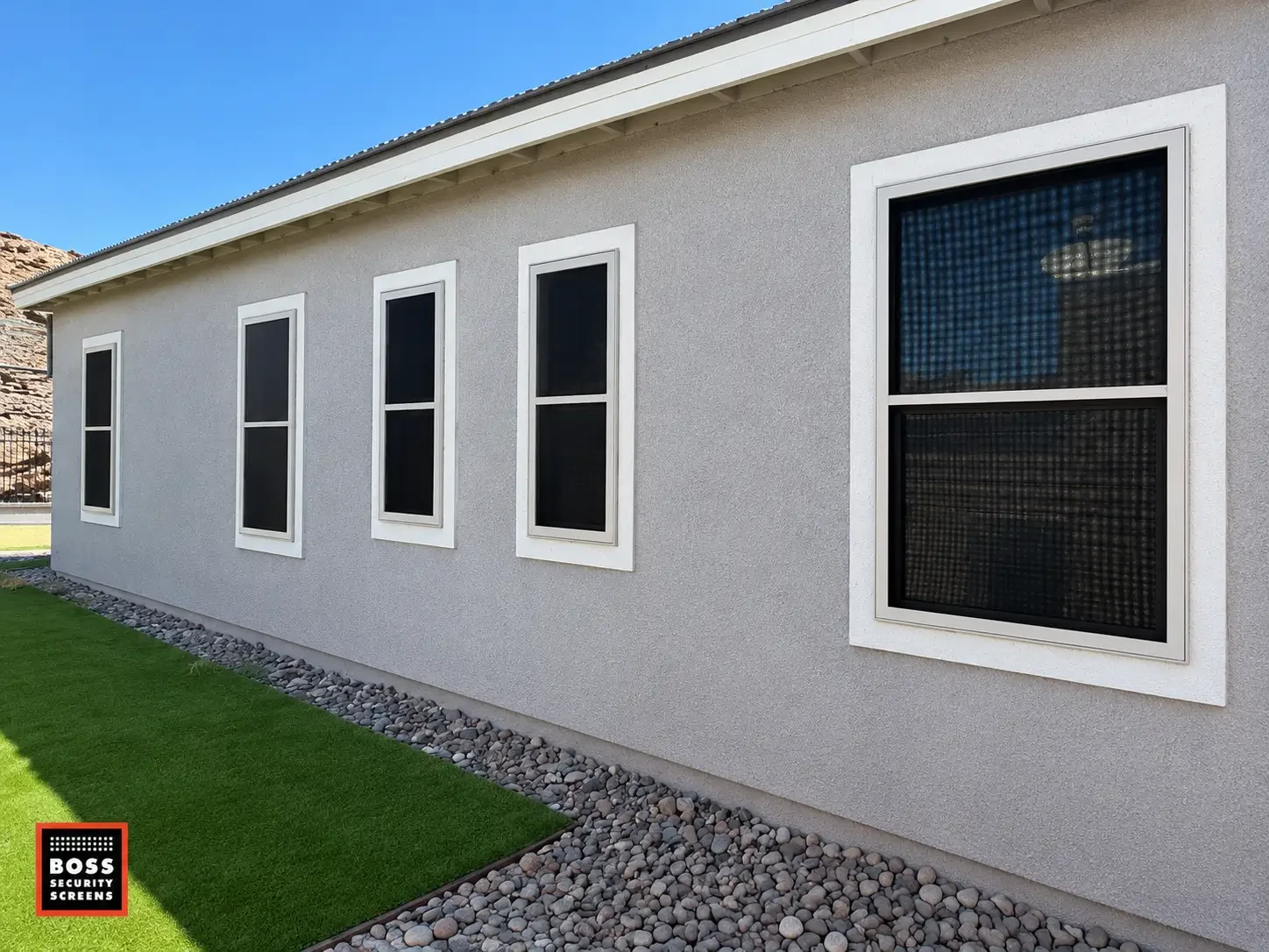 Encino side yard with dark security screen panels on several windows, protecting side access points while keeping the exterior simple and unobtrusive.