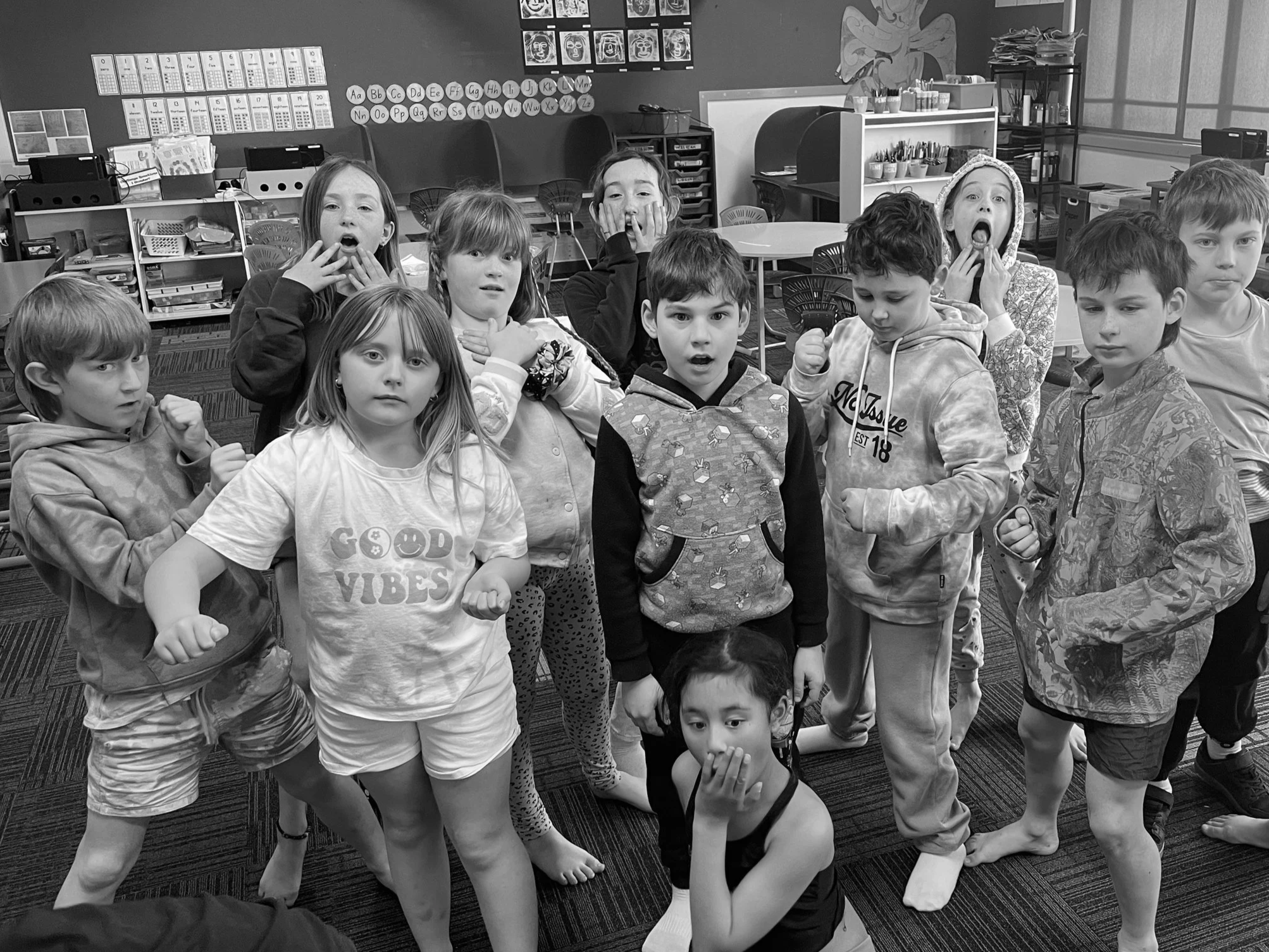 A group of children in a classroom posing