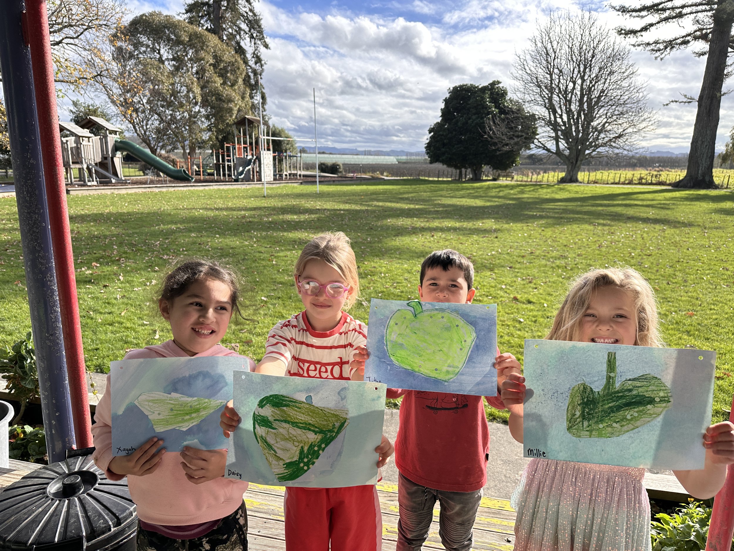 4 students with their Matariki Leaf Map