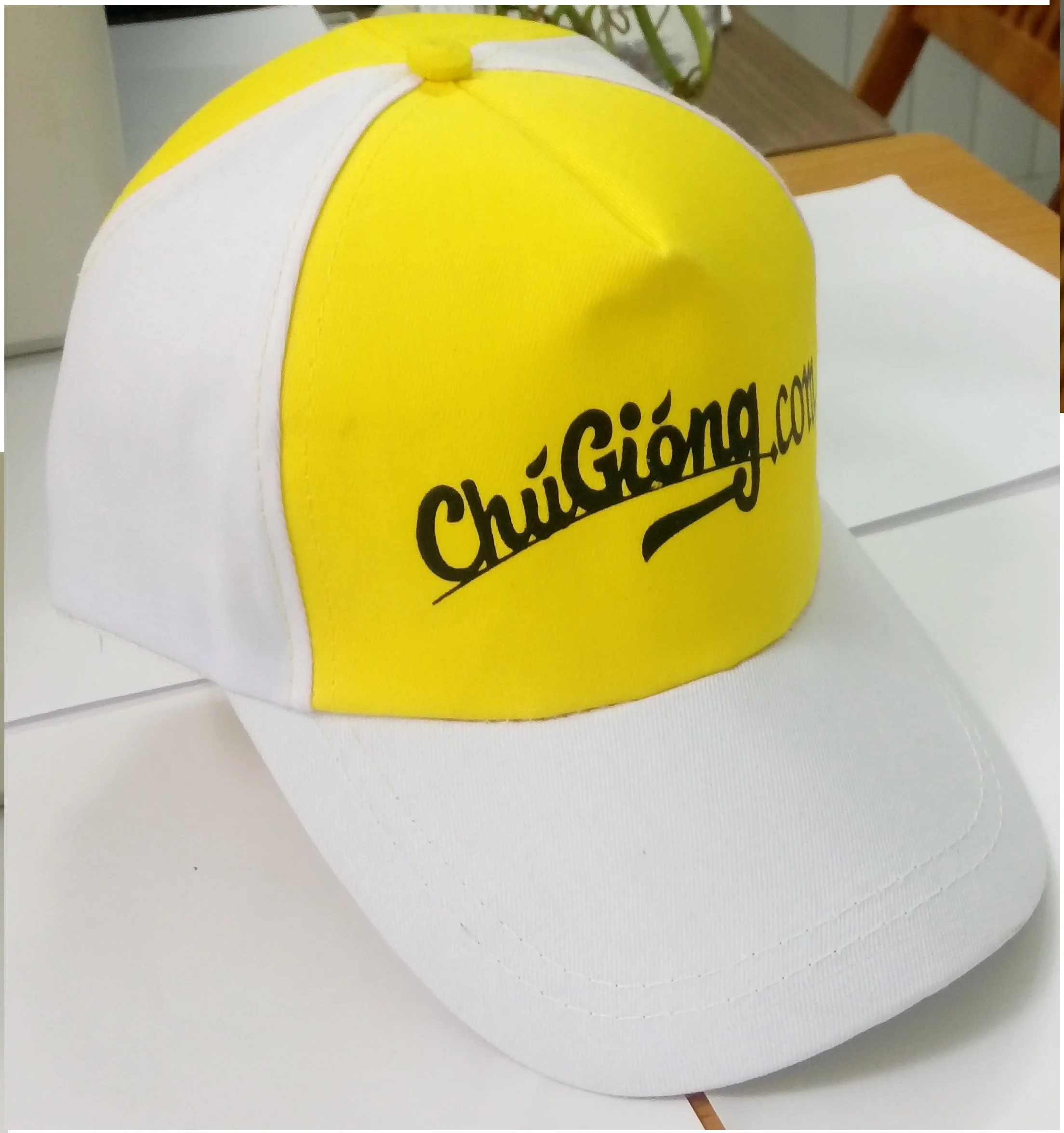 A white and yellow trucker cap with the logo 'ChuiGiang.com' in black text on the front yellow panel.