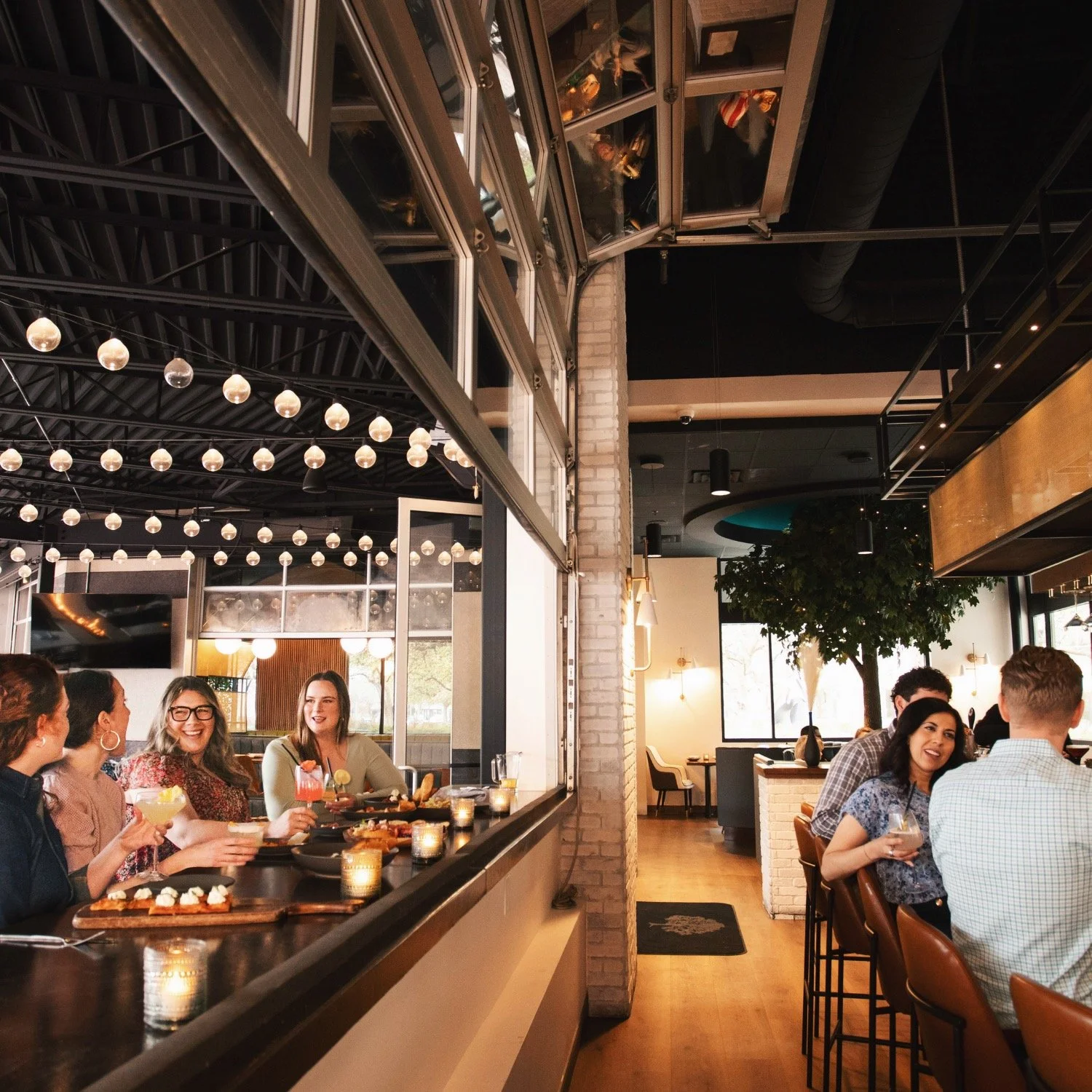 The bar opening onto the patio through the garage door