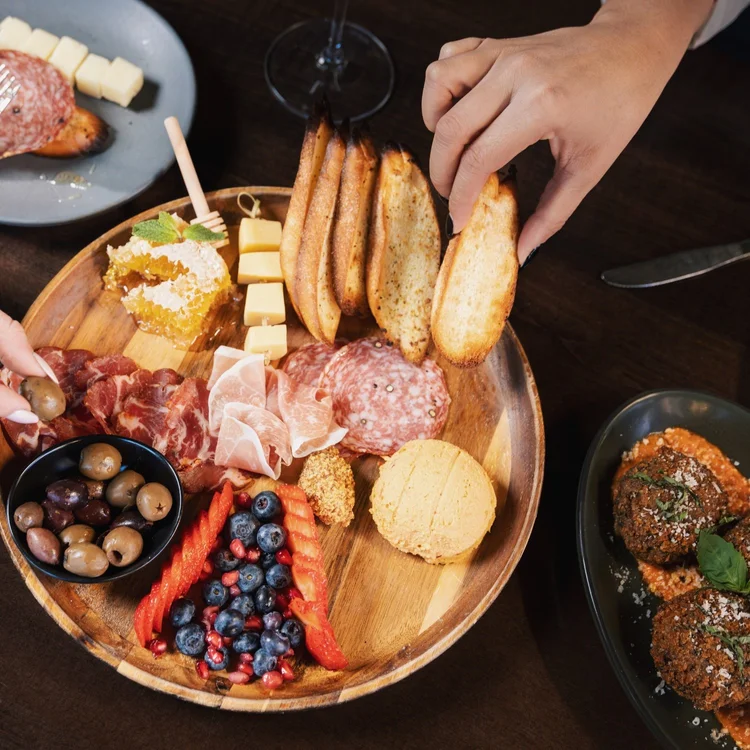 Hands reaching for a shared board