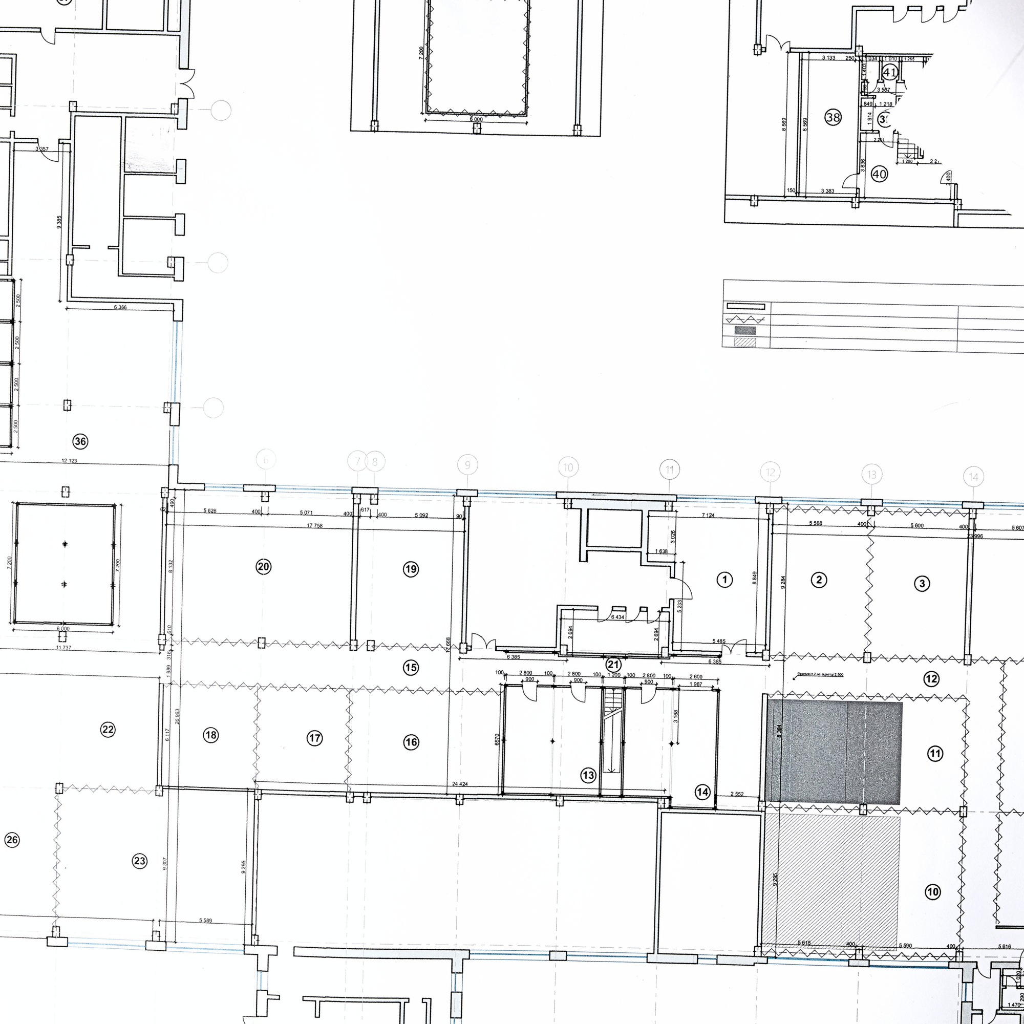 Architectural 2d floor plan with various rooms, hallways, and structural details.