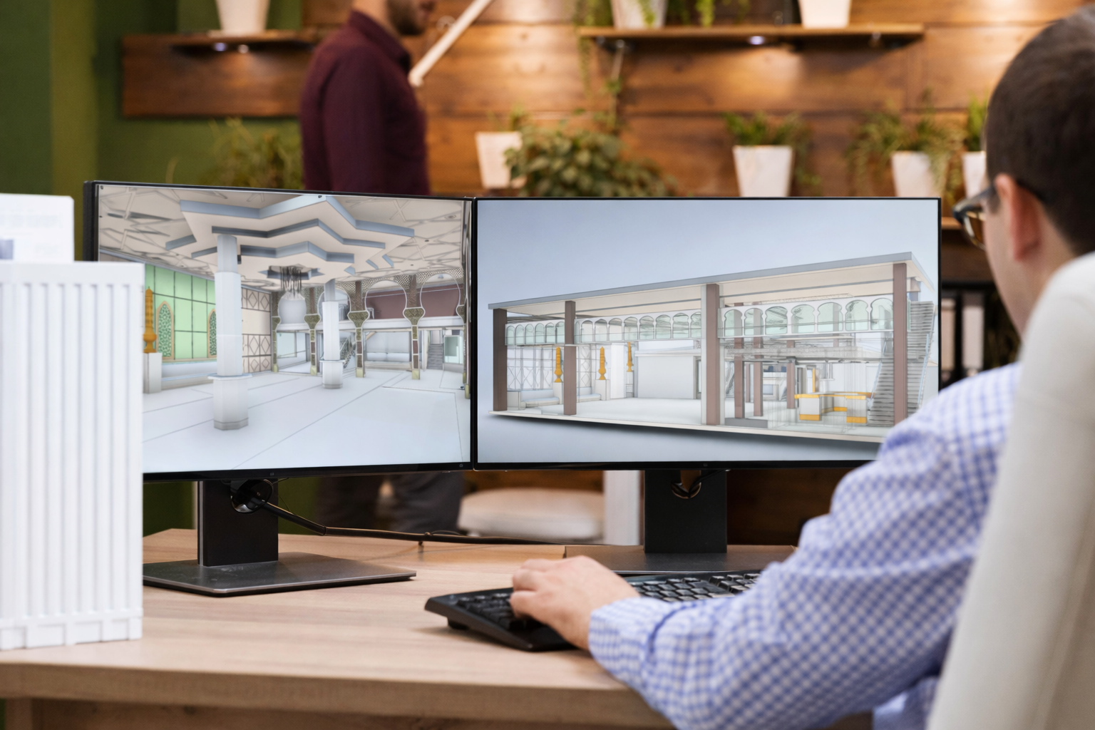 Man looking at computer screens with revit 3d models of historic location