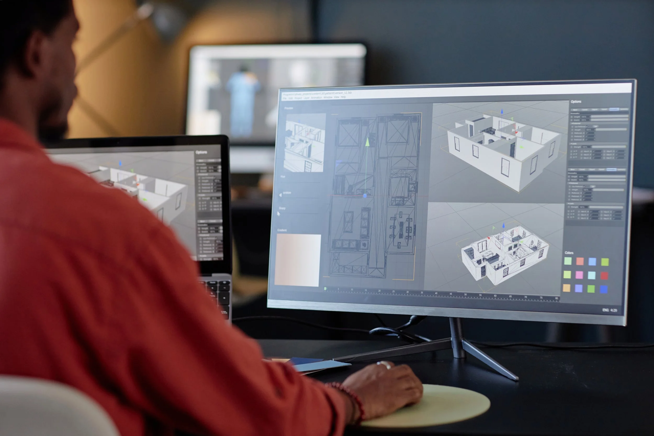 Man looking at a 3d render of a residential home on a computer
