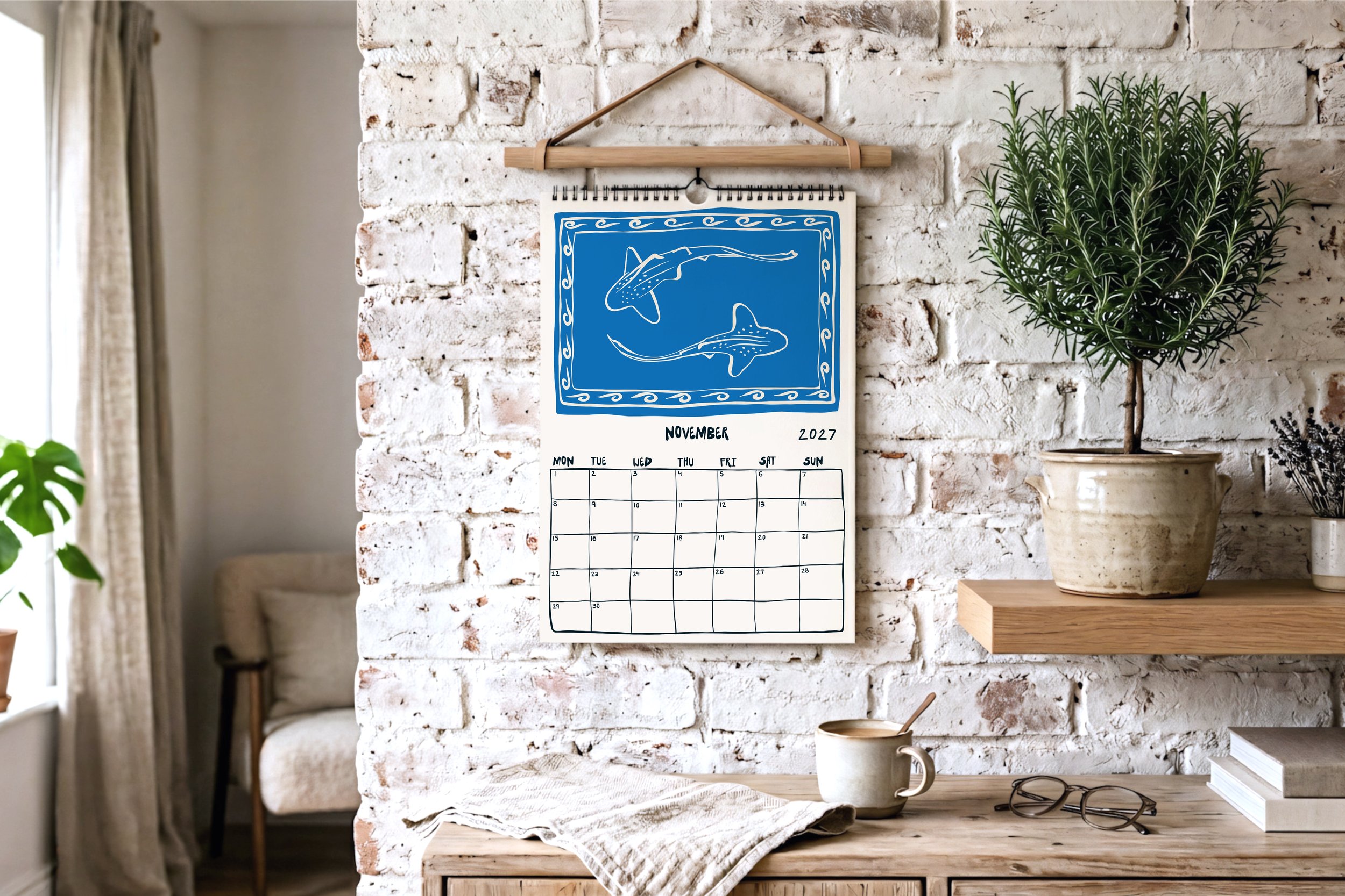 November calendar page with a blue lino-print illustration of two leopard sharks swimming in the ocean.
