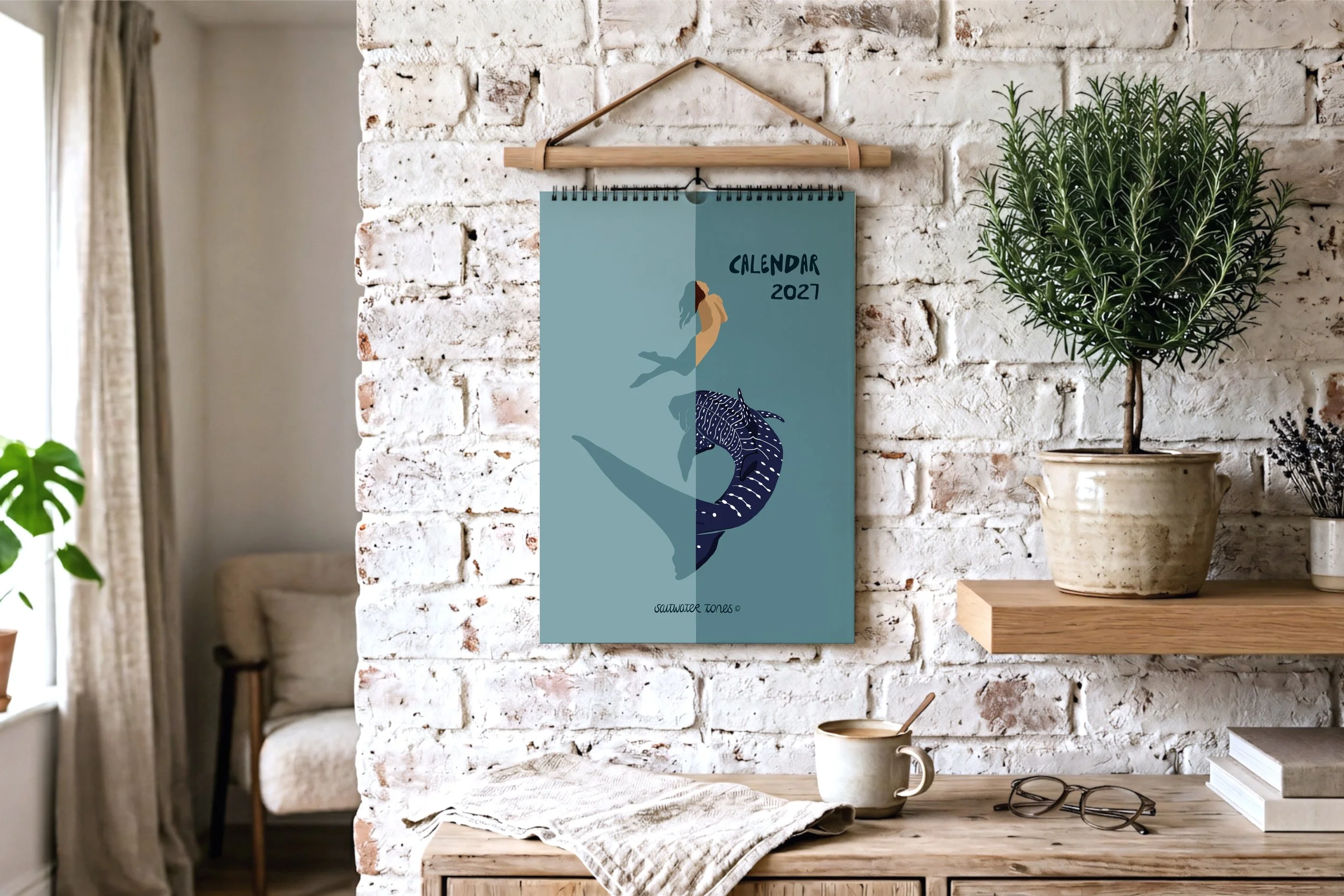 January calendar page illustrated with manta rays and a freediver descending through deep blue water