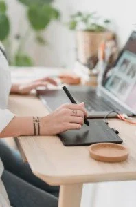 business owner with laptop seeing the benefits of online networking