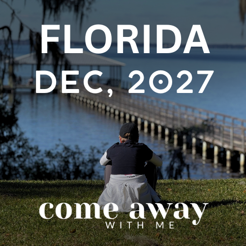 Person sitting on grass near water with a dock, palm trees, and a small house in the background, promoting a Florida trip in December 2027. A Christian silent retreat.