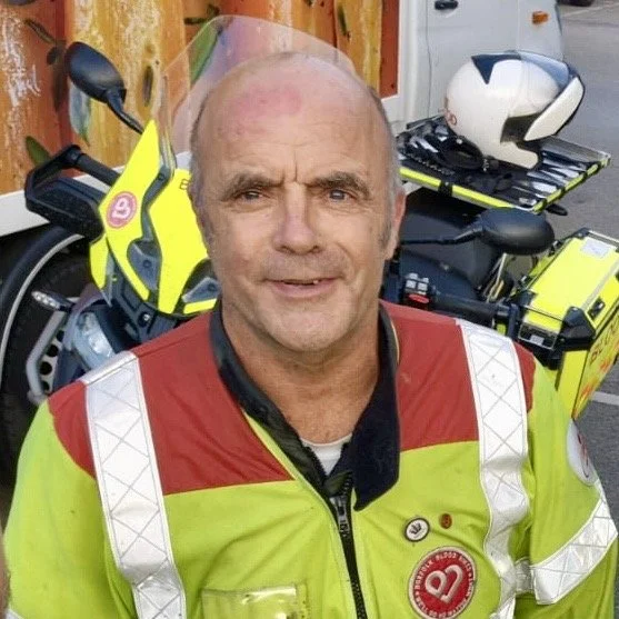 Icon of a heart with a location pin integrated into the design, on a red background.