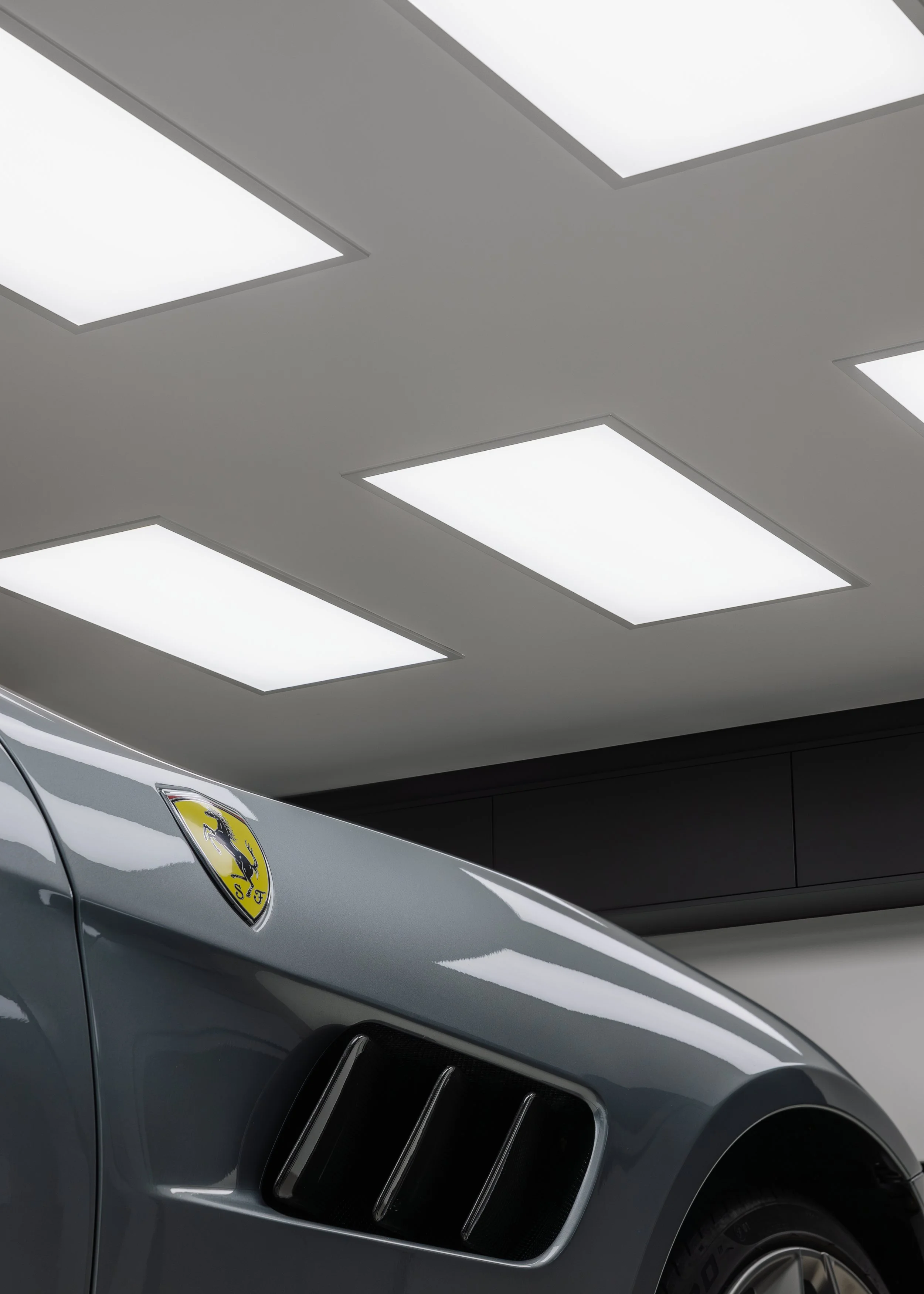 A modern, state-of-the-art paint protection film instillation studio. Featuring a silver Ferrari GTC 4 Lusso. This car has been wrapped in STEK DYNO gloss PPF, using bespoke paint protection film patterns which have been accurately cut to size using 