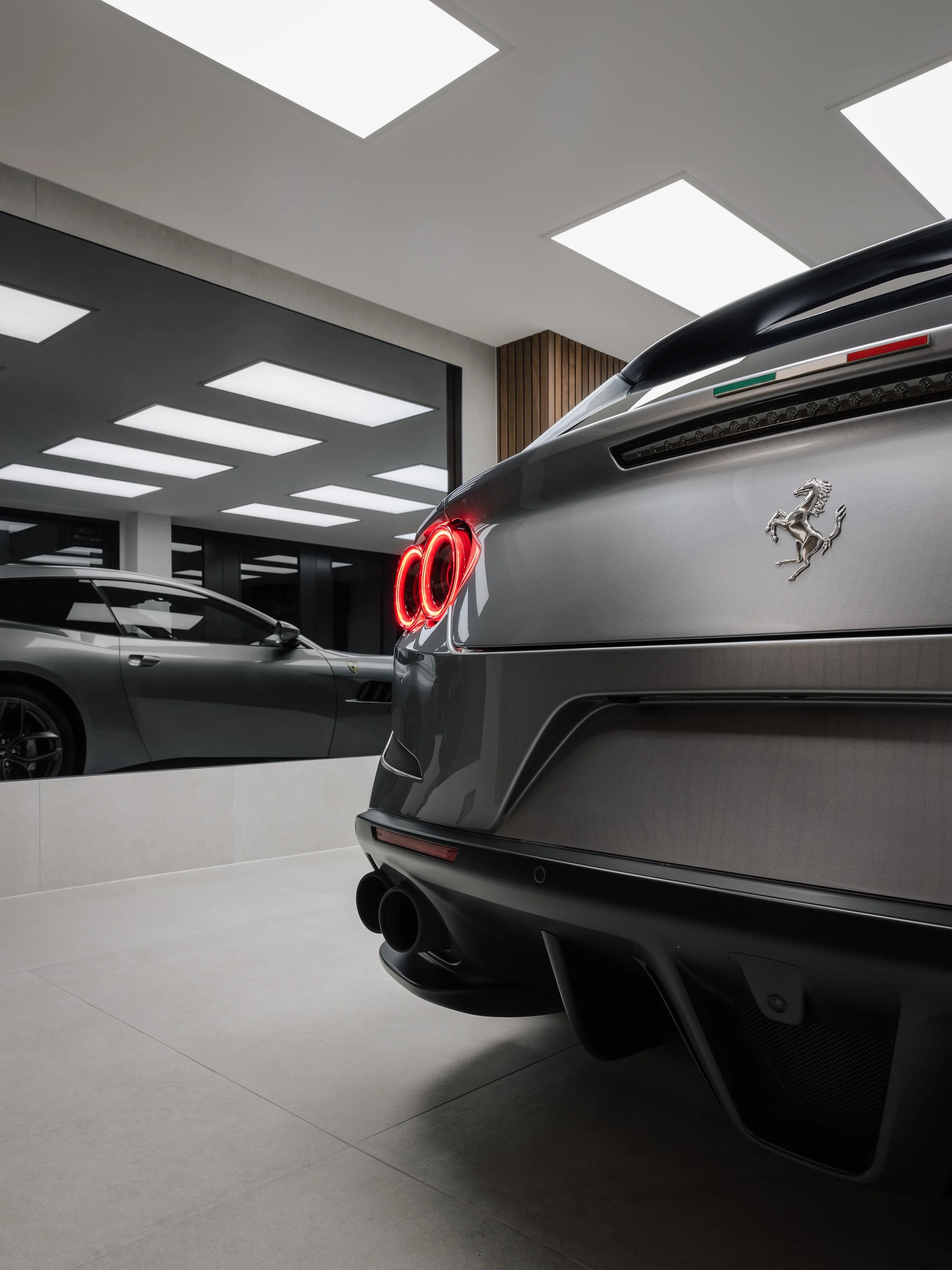 A modern, state-of-the-art paint protection film instillation studio. Featuring a silver Ferrari GTC 4 Lusso. This car has been wrapped in STEK DYNO gloss PPF, using bespoke paint protection film patterns which have been accurately cut to size using 