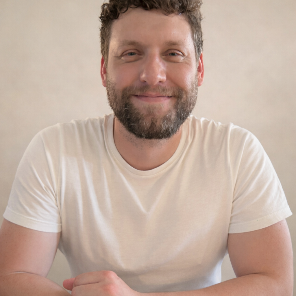Man in a white t-shirt smiling