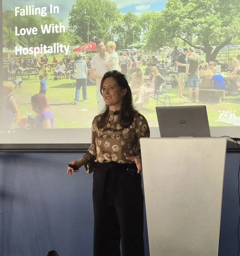 Cassie Davison speaking to an audience of hospitality professionals