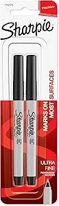 Two black Sharpie markers in packaging labeled as Ultra Fine Point, with the brand name Sharpie visible.