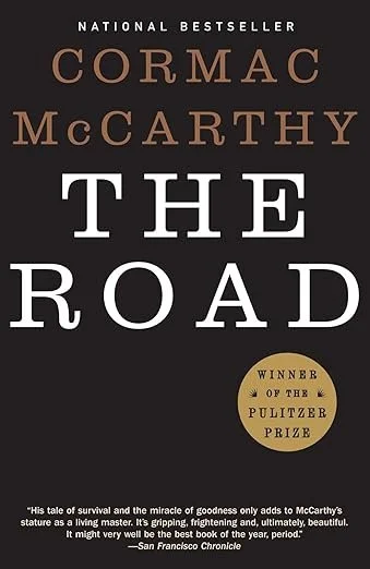 Cover of the book titled "The Road" by Cormac McCarthy, a National Bestseller and Pulitzer Prize winner.