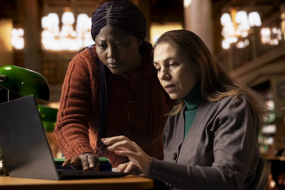 two women looking at a laptop