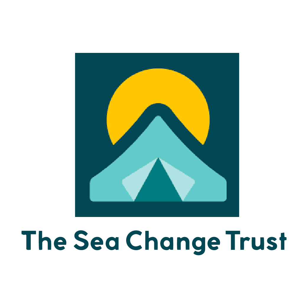 Logo of The Sea Change Trust featuring a stylized mountain with a yellow sun behind it.