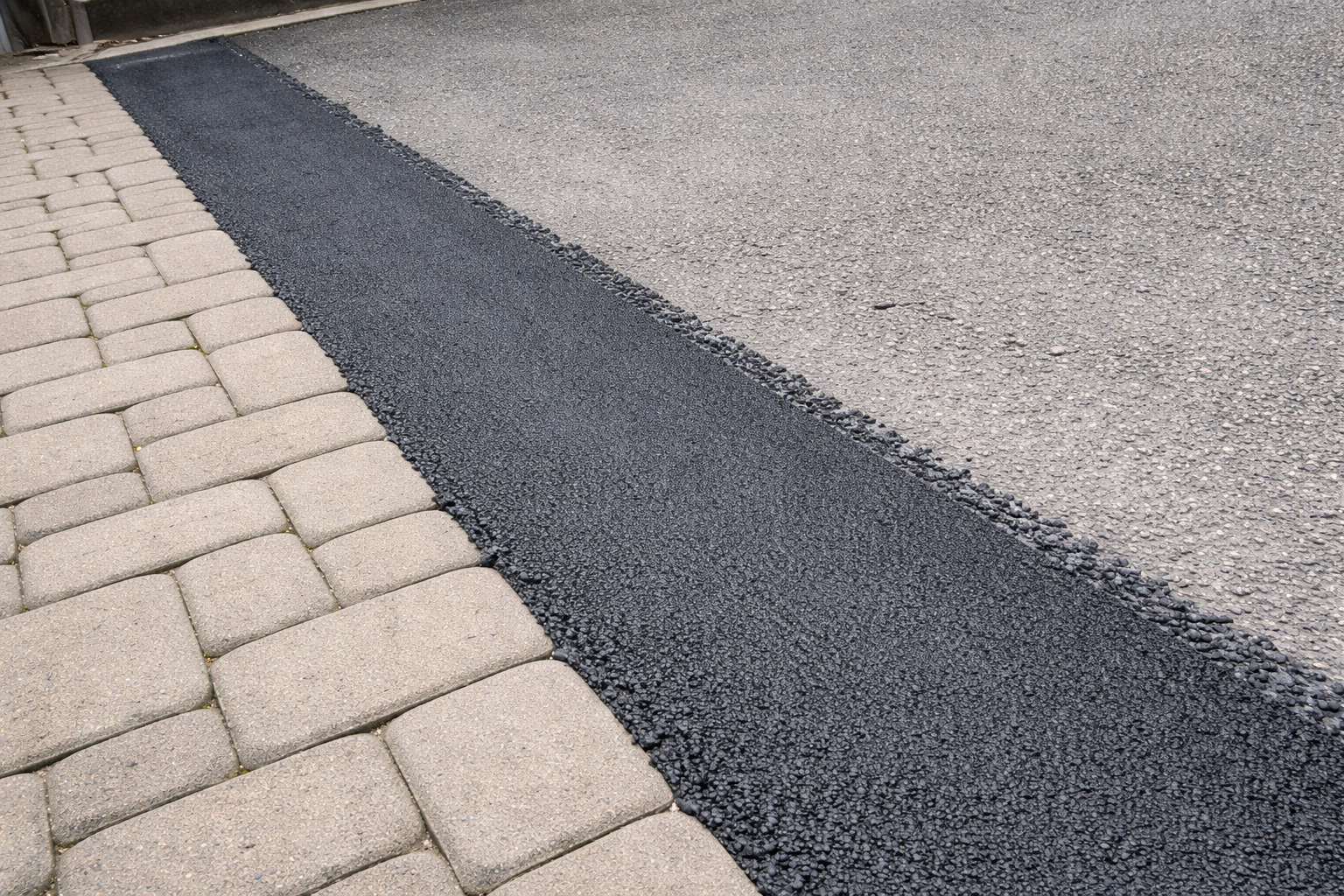 Freshly patched asphalt connection.png