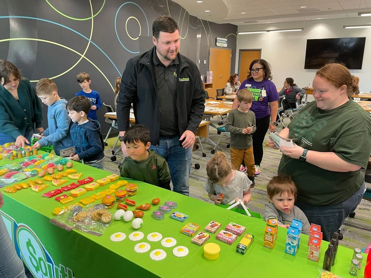 children looking at a table of candies in the shape of food