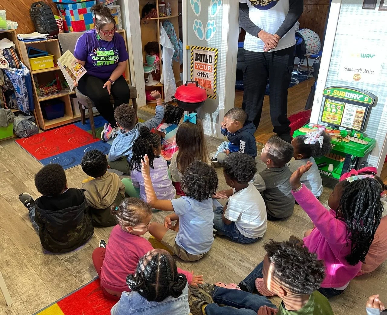 small children gathered around a SWLA financial counselor 