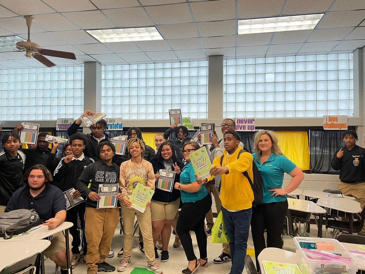 SWLA financial counseling student show off booklets and sheet guides