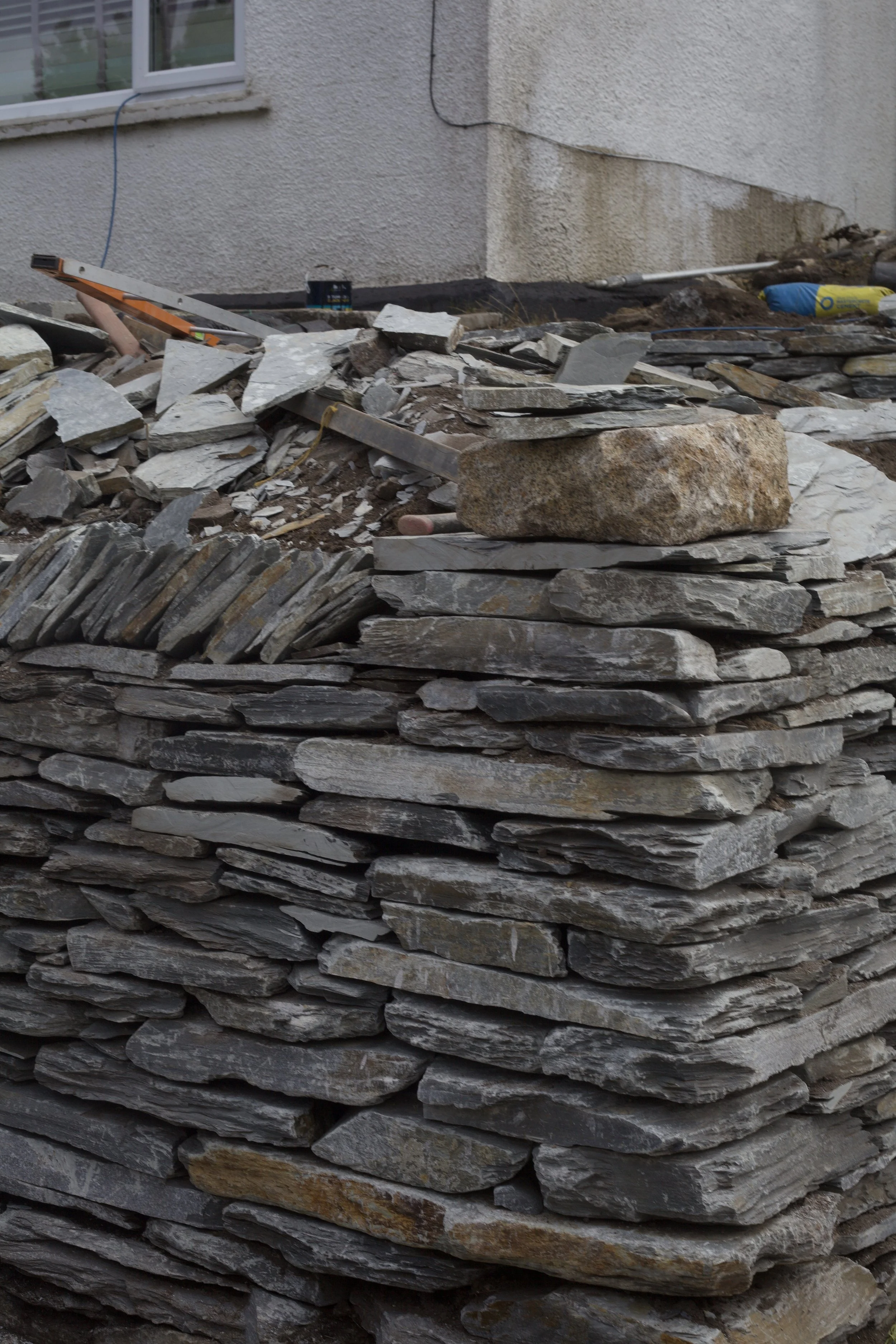 Drystone wall corner with Granite capping and Slate herring bone