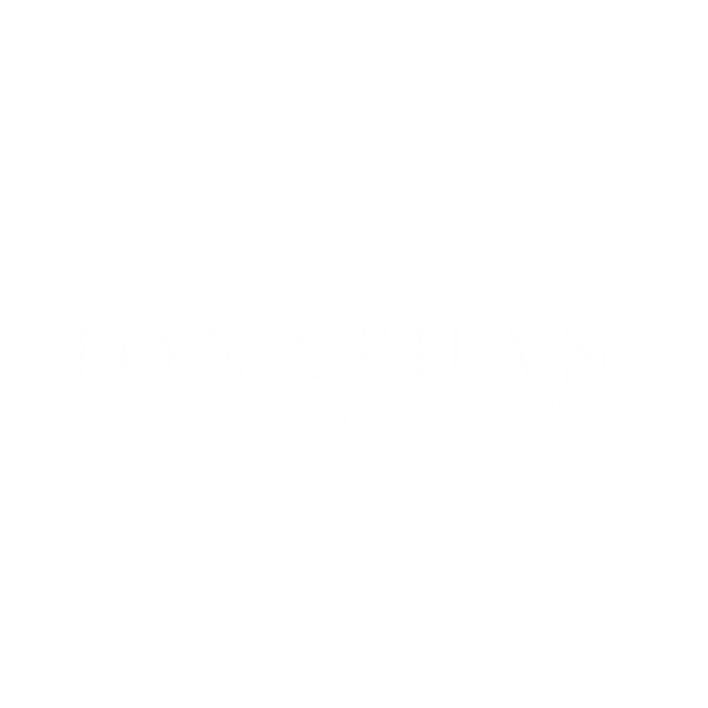 Black background with the text 'JONATHAN aaron' in white, with 'JONATHAN' in uppercase serif font and 'aaron' in cursive.