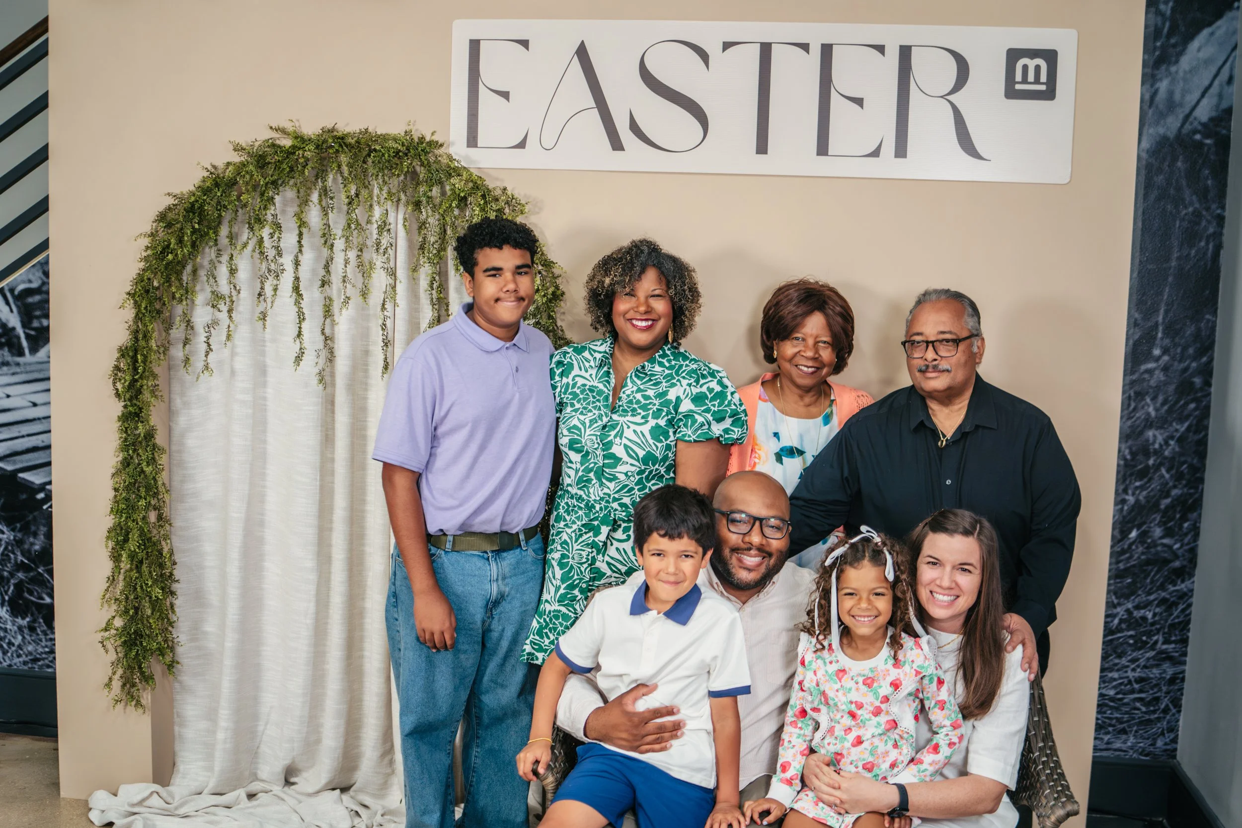 Family posing in front of photobooth at Mission City Church on Easter Sunday at Mission City Church in San Antonio, Texas