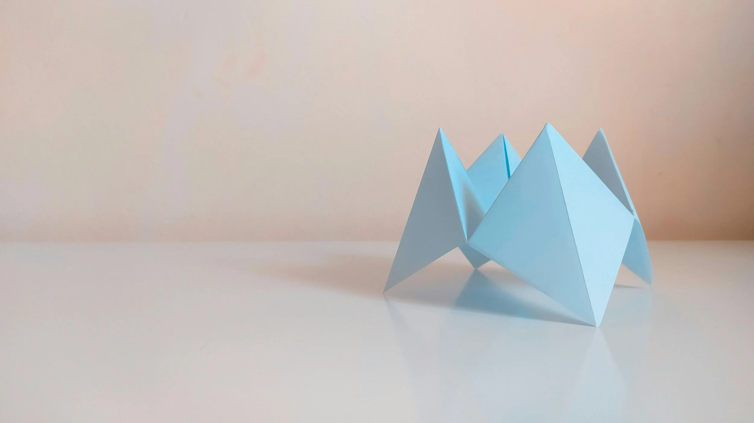 Abstract origami mountain peaks – symbolizing mindset shift and leadership elevation