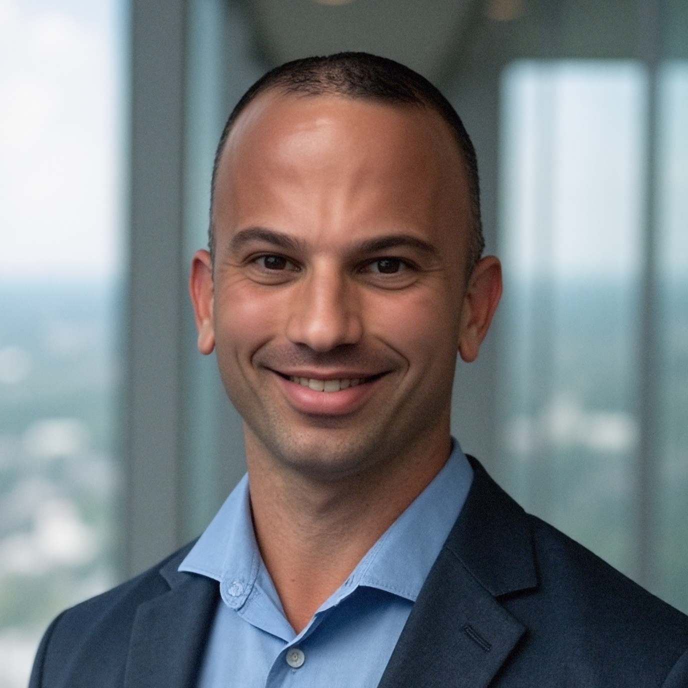 Silhouette of a person with a bright circular light behind their head in a dark setting.