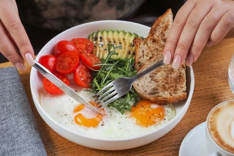 Woman eating protein breakfast